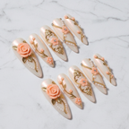 Full set 10 cream ivory stiletto press-on nails with 3D peach rose gold baroque embellishments on marble background custom press-on nails — LuxepressCo
