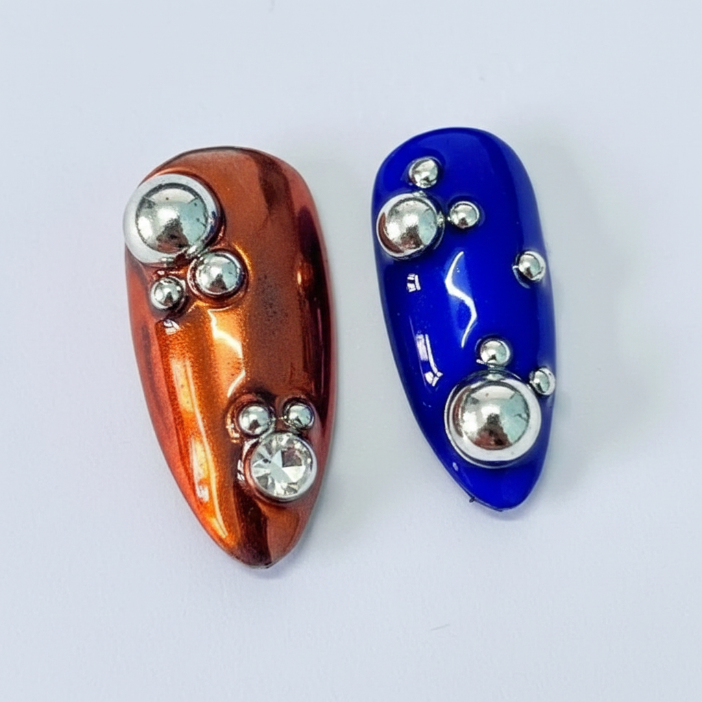 Macro close-up burnt orange and cobalt blue chrome salon-quality press-on nails rhinestone ball beads — LuxepressCo