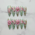 Flat lay top-down full set 10 mint green 3D floral gold foil pearl stiletto custom press-on nails — LuxepressCo