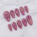 10-piece pink chrome heart coquette almond press-on nails full set on marble studio hero shot — custom press-on nails — LuxepressCo