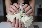 Fair-skin hands wearing kawaii cat pearl star custom press-on nails holding white peonies — LuxepressCo