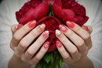 Light skin hands holding red peonies wearing red jelly floral reusable nails salon-quality — LuxepressCo