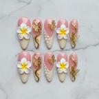 Flat lay top-down full set 10 pink plumeria butterfly pearl gold custom press-on nails white marble — LuxepressCo