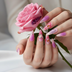 Light skin hands holding pink rose wearing angel wing heart chrome custom press-on nails pink purple stiletto — LuxepressCo