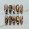 Flat lay top-down full set 10 nude gold frame animal print floral square press-on nails studio light custom press-on nails — LuxepressCo
