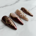 Close-up sheer nude gold vine floral reusable press-on nails salon-quality — LuxepressCo