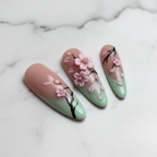 Close-up cherry blossom press-on nails glossy texture marble background salon-quality nails — LuxepressCo