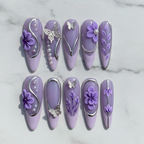 Flat lay top-down full set 10 lavender purple 3D floral silver butterfly salon-quality nails white marble — LuxepressCo